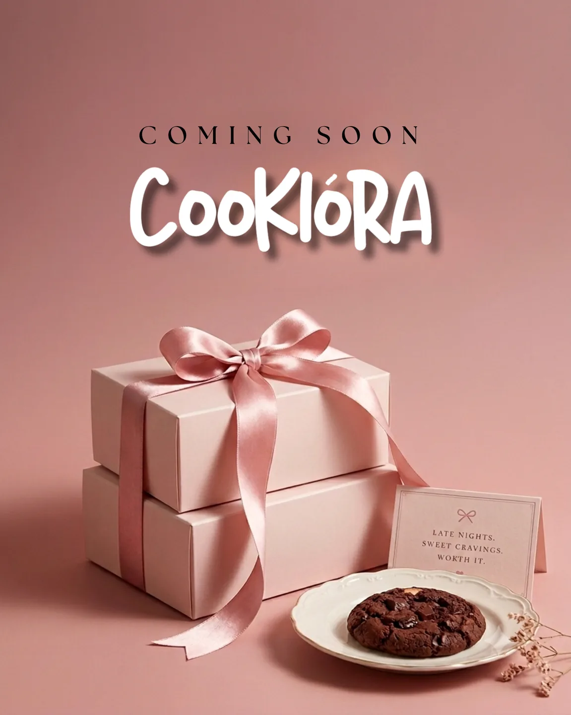 Coming soon: pink gift boxes with a satin bow and a chocolate cookie on a plate