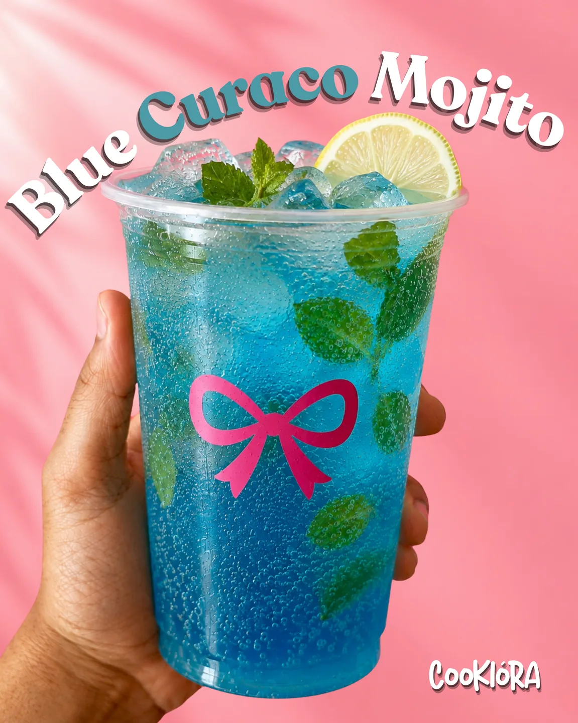A hand holding a Blue Curaçao Mojito with lemon and mint