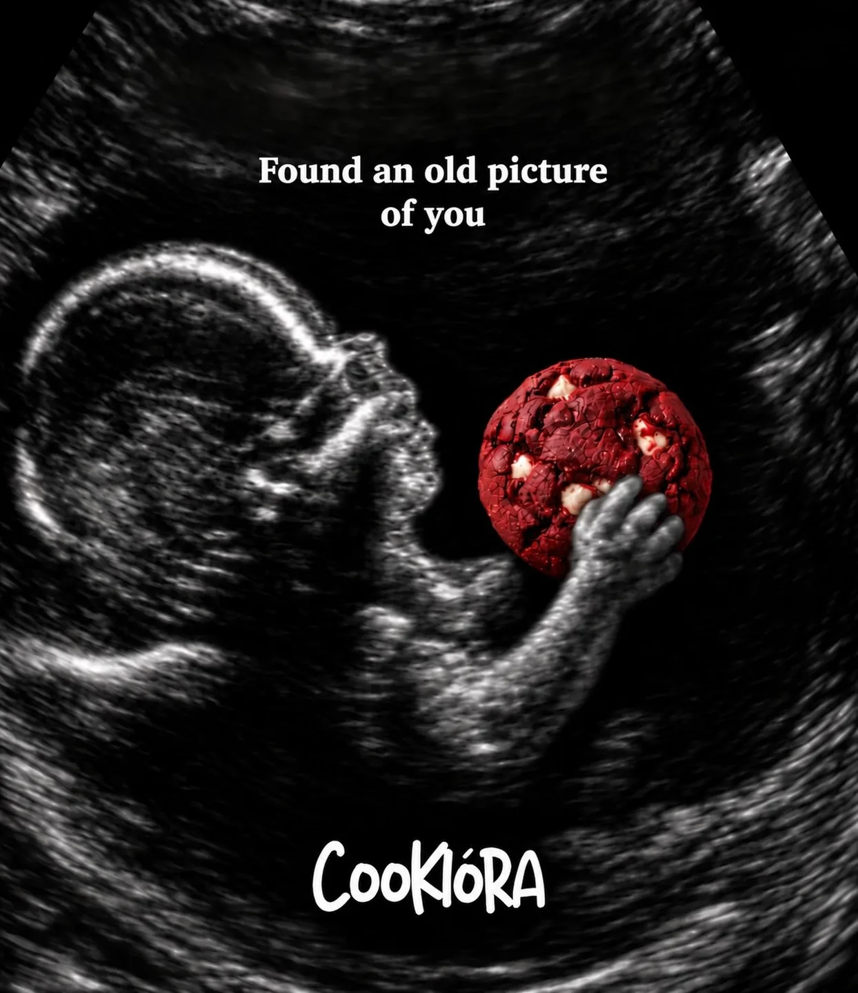 An ultrasound scan of a baby clutching a red velvet cookie: found an old picture of you
